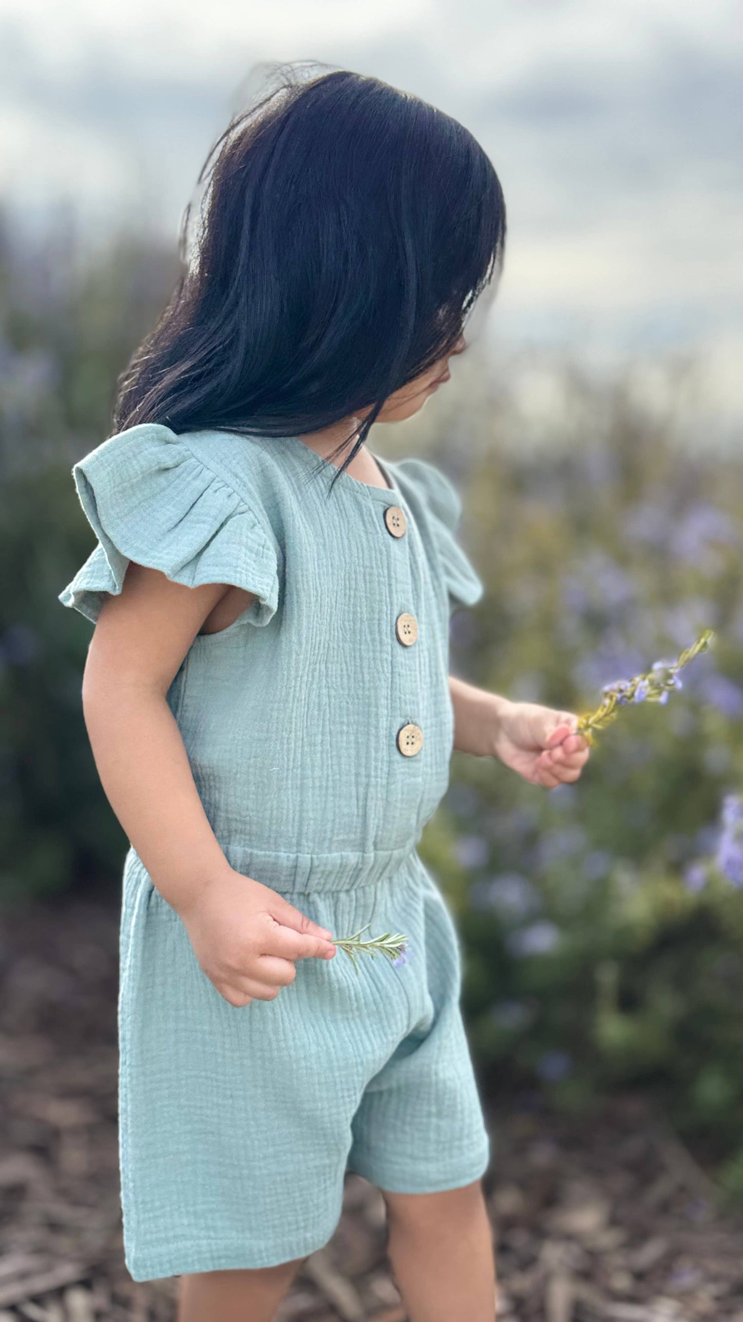 Baby in Lucy Sage Organic Muslin Cap-Sleeve Romper — breathable summer heatwave outfit