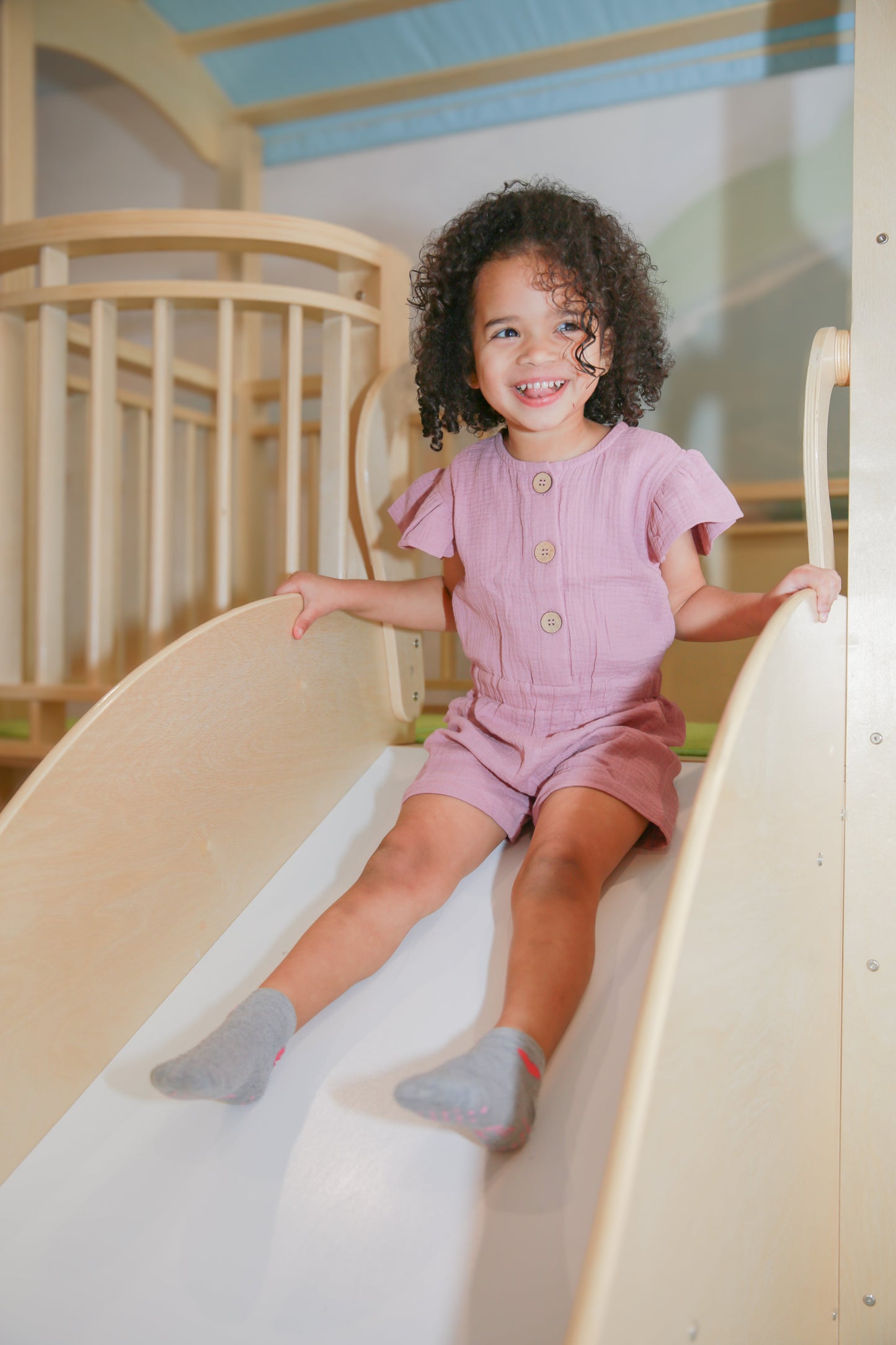 Baby in Lucy Thistle Organic Muslin Cap-Sleeve Romper — coordinated summer family palette