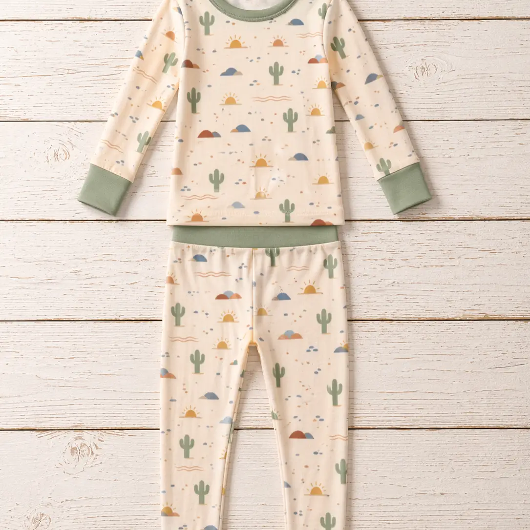 Desert Dawn two-piece pajamas with cactus and sun motifs and sage-green trim