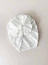 White broderie anglaise bow turban flatlay