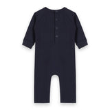Close-up detail of safari animal embroidery on organic cotton baby jumpsuit showing quality stitching