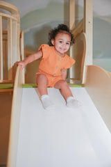 Lucy Marigold Organic Muslin Cap-Sleeve Romper by The Honey and Bro Co. - Lifestyle View