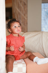 Daphne Coral Organic Linen Blend Romper by The Honey and Bro Co. - Lifestyle View
