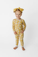 Sunny Daisy Bamboo Two-Piece Pajama Set - Front View on Girl - Yellow Daisy Print Long Sleeve Top and Pants