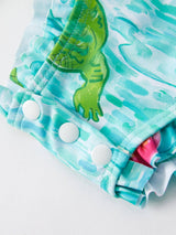 Crocodile Green Girls Swimsuit - Baby Girl Wearing One-Piece at Beach