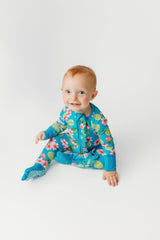 Flower and Lime Ruffle Butt Bamboo Footie Pajamas - Front View on Baby - Teal Tropical Print with Zip Closure