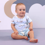 Baby boy wearing Taking Flight organic cotton t-shirt with vintage airplane print in light blue, paired with pale blue ribbed shorts