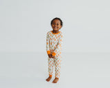 Smiling girl standing in Little Sprouts Soluna bamboo two-piece pajamas