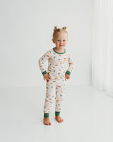 Toddler girl standing in Desert Dawn Soluna bamboo two-piece pajamas with sage cuffs