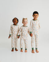 Three children holding hands in matching Desert Dawn Soluna bamboo two-piece pajamas