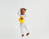 Toddler holding yellow duck toy in Royal Ducklings Soluna bamboo two-piece pajamas
