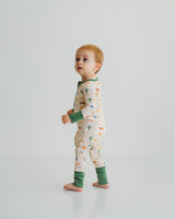 Baby standing in Desert Dawn Soluna bamboo zippy with sage cuffs