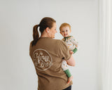 Baby wearing Desert Dawn Soluna bamboo zippy held by mom in Honey and Bro Co shirt