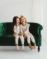 Two children smiling in matching Desert Dawn Soluna bamboo pajama sets