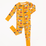 Front flat lay of the Let the Gourd Times Roll zip footie with pumpkin-and-truck print and mustard cuffs.
