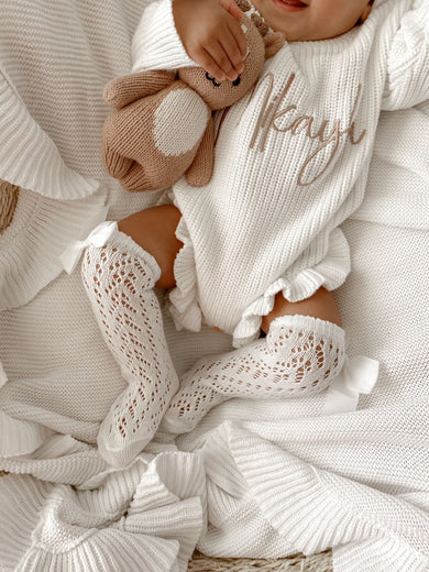 Spanish openwork lace knee high bow socks in white for baby, front view showing delicate lace pattern and bow detail