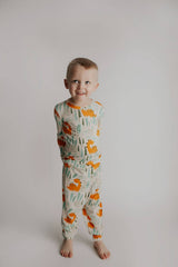 Dinosaur Modal Toddler Two-Piece Pajama Set by Three Little Tots - Flat Lay
