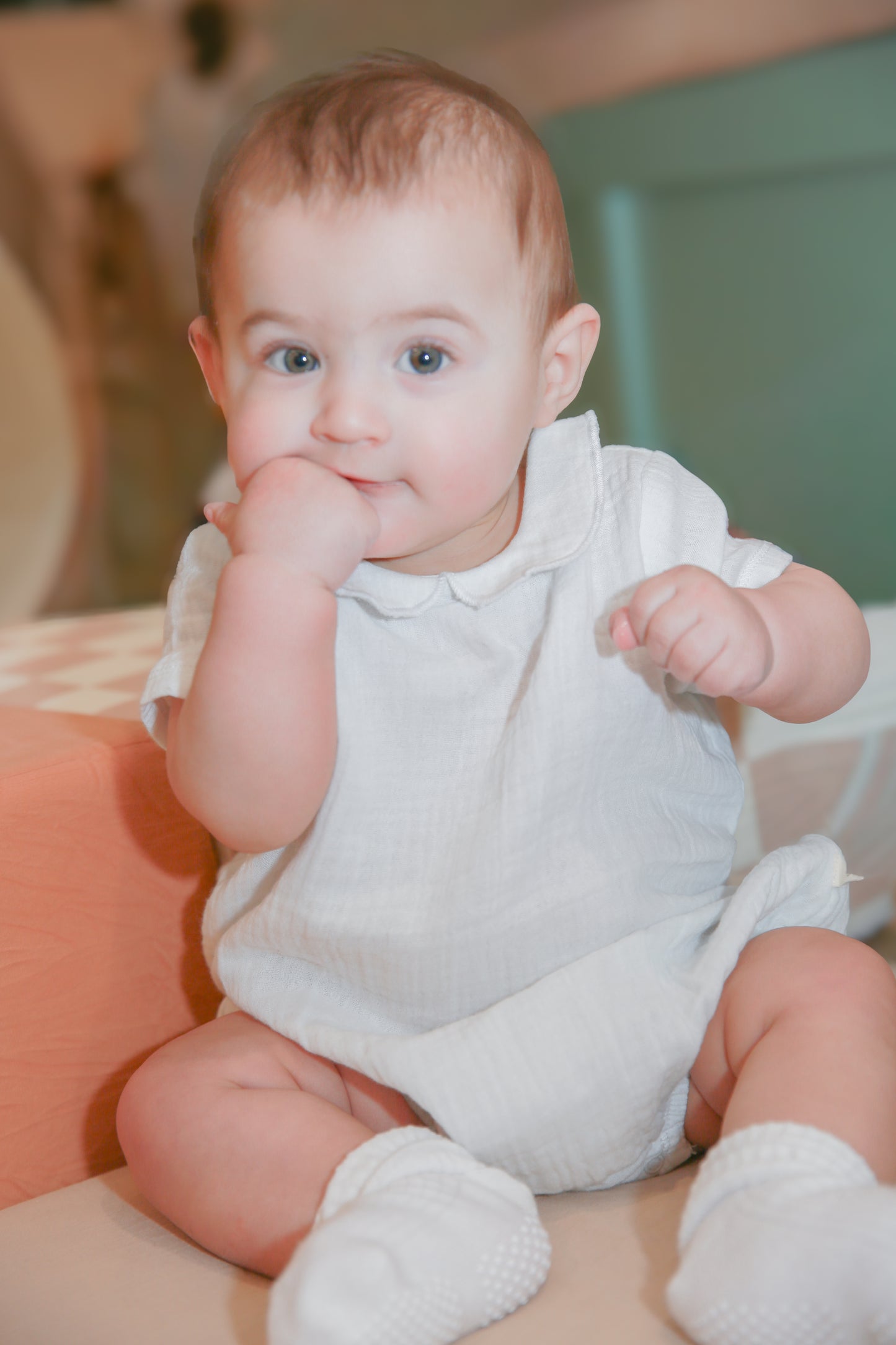 Baby girl model Logan wearing Organic Muslin Peter Pan Collar Bubble Romper - white with scalloped collar