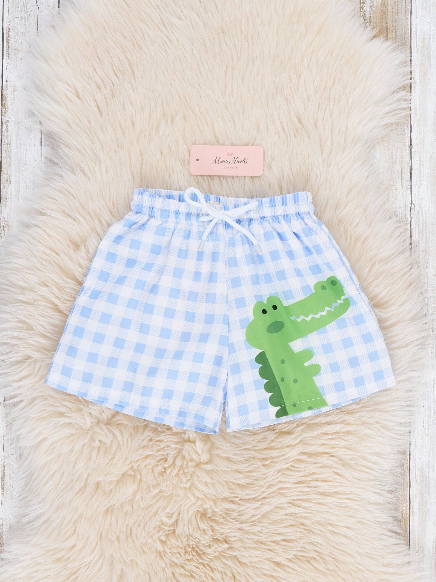 Gingham Gator Splash Trunk for baby and toddler boys featuring green gingham check pattern with playful gator graphic and elastic drawstring waistband by Marie Nicole Clothing