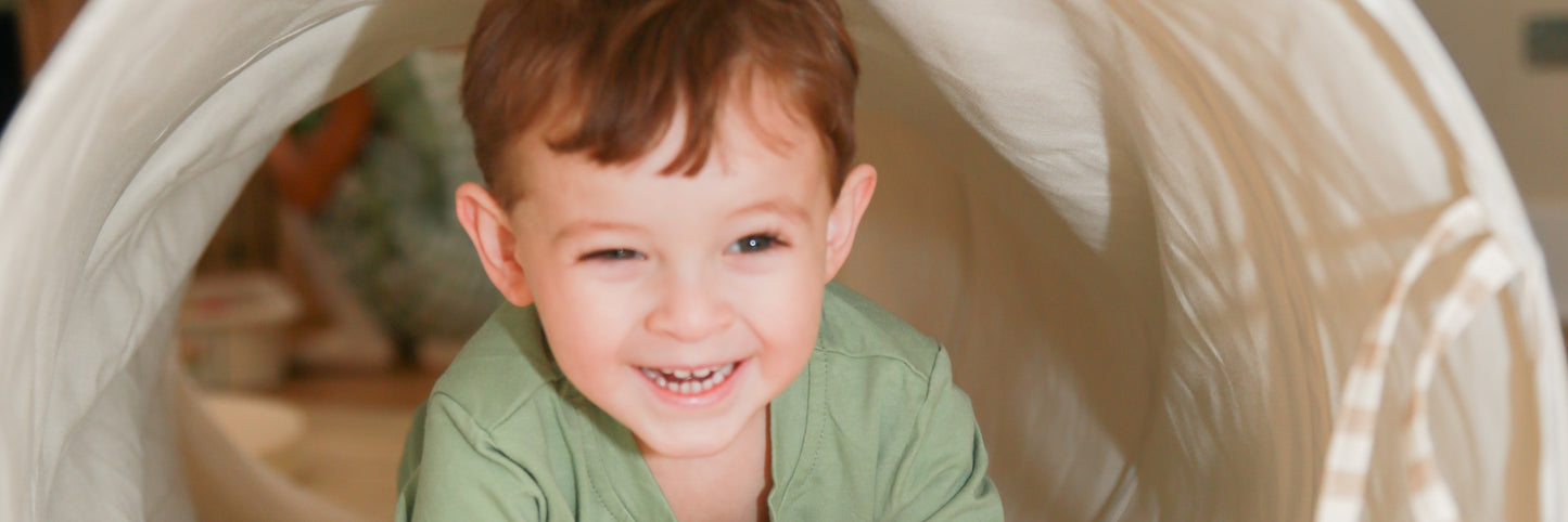 FAQ hero - toddler crawling through play tunnel