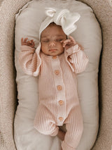 Long Flutter Ribbed Romper | Pink by The Honey and Bro Co. - Lifestyle View