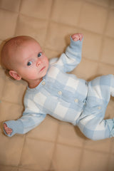 Baby in blue gingham knit romper - detail button closure shot