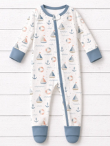 Harbor Dreams Zippy by The Honey and Bro Co. - Bamboo zippy pajama flat lay with dusty blue trim and nautical sailboat print