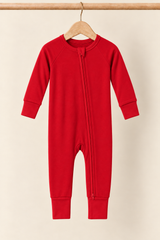 Holly Berry solid red convertible zippy pajamas on a wooden hanger against a creamy background