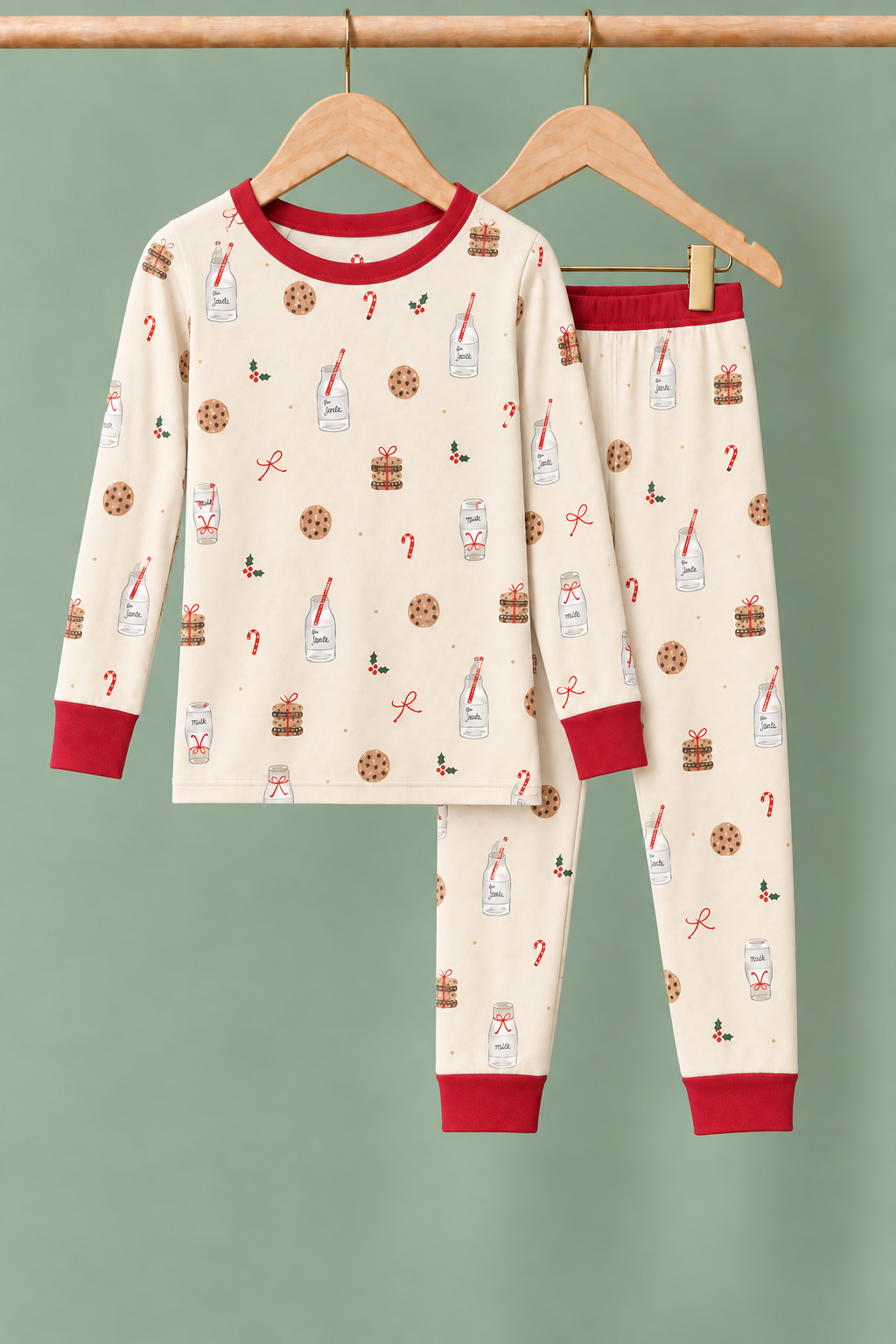 Milk & Cookies Zinza™ Kids Two-Piece Pajama Set on wooden hangers against a sage background