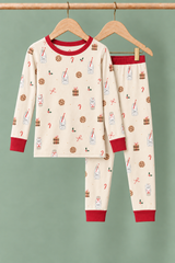 Milk & Cookies Zinza™ Kids Two-Piece Pajama Set on wooden hangers against a sage background
