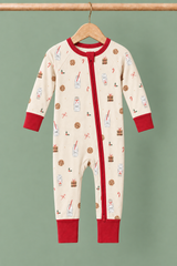 Milk & Cookies ivory convertible zippy pajamas with red trim on a wooden hanger against a contrasting muted sage background
