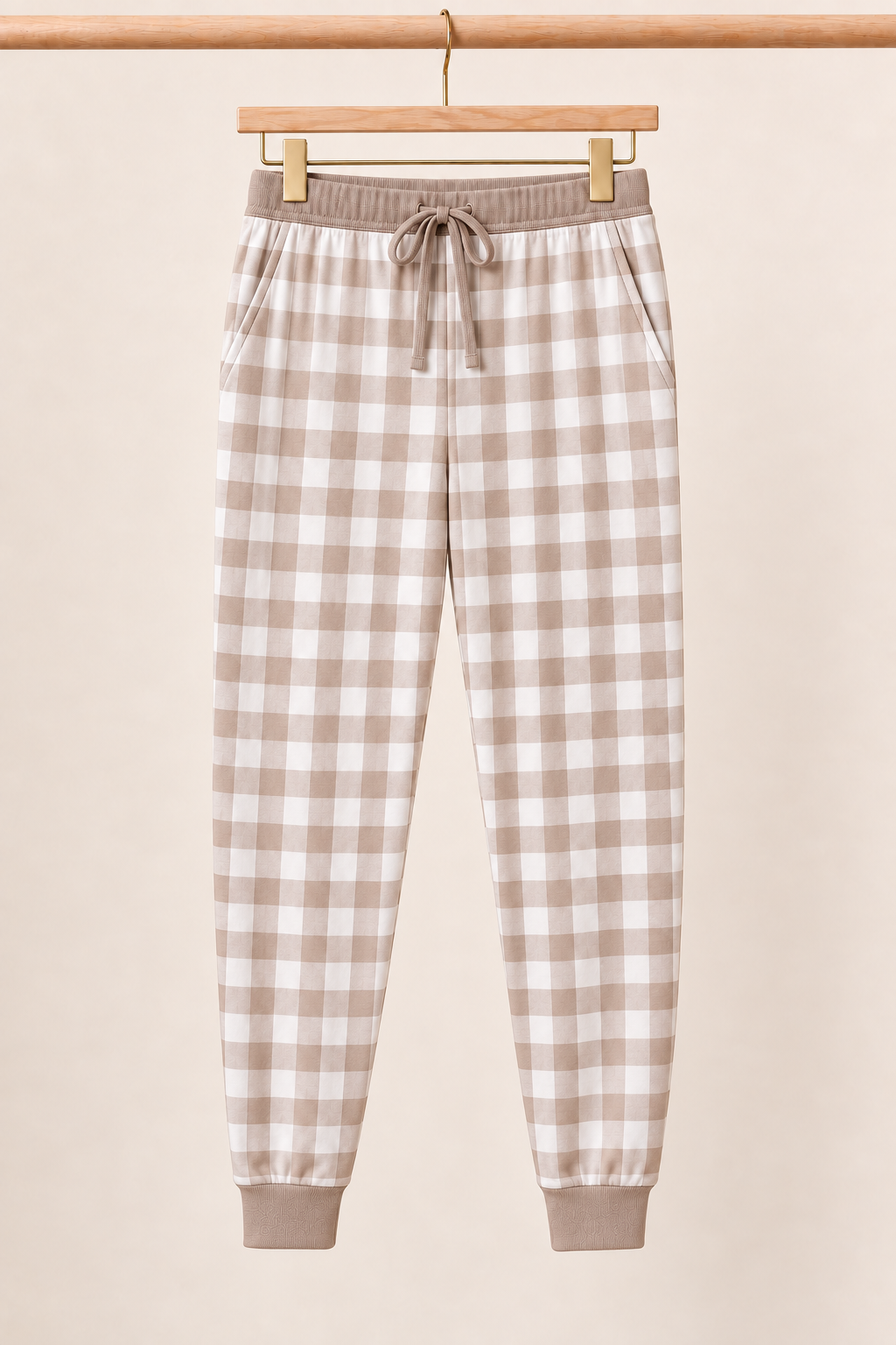 Mocha Gingham Zinza™ Adult Pajama Jogger on wooden hangers against a warm cream background