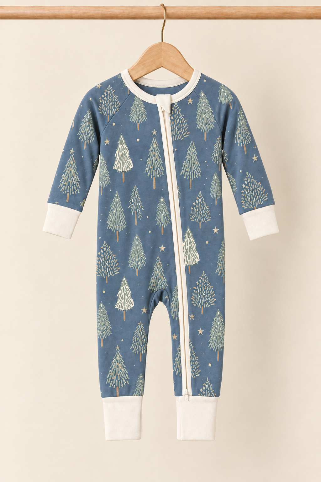 Starlit Evergreens convertible zippy on wooden hanger against a creamy background