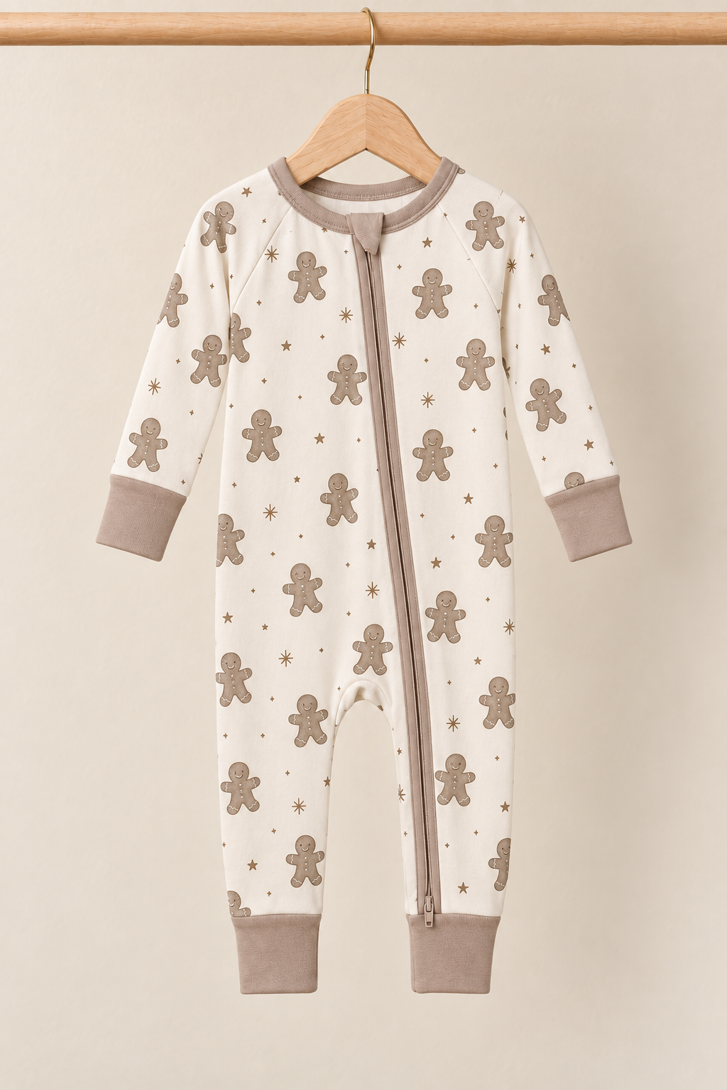 Winter Gingerbread Zinza™ Convertible Zippy Pajama on wooden hangers against a warm cream background