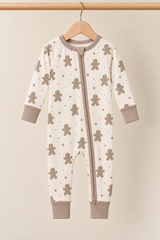 Winter Gingerbread Zinza™ Convertible Zippy Pajama on wooden hangers against a warm cream background