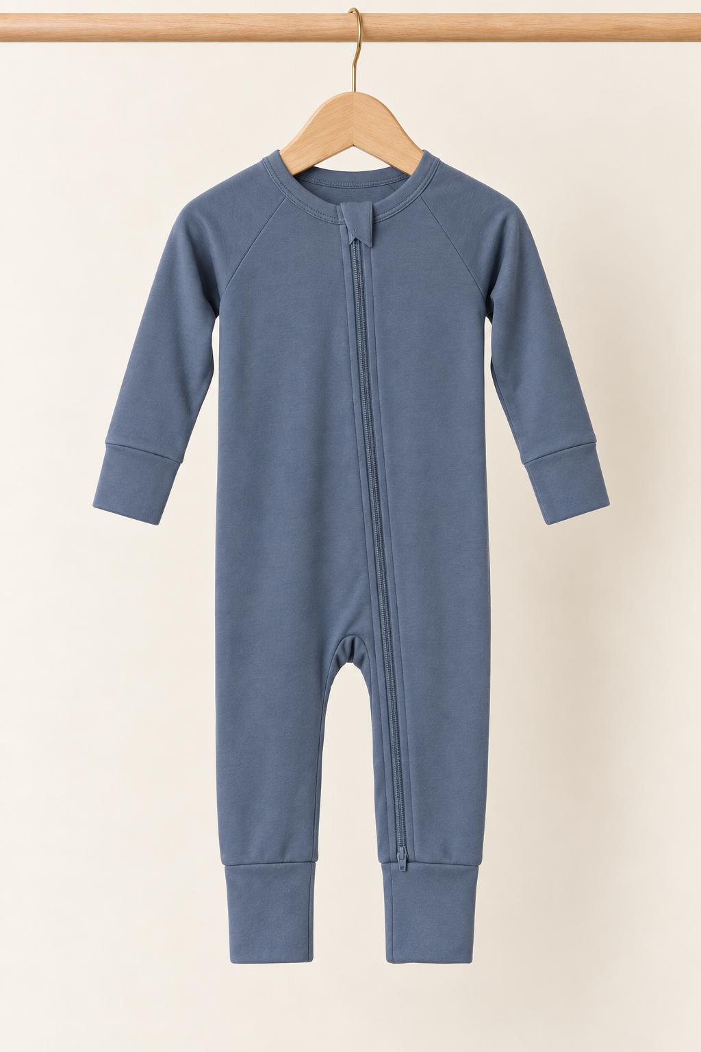 Winter Slate Zinza™ Convertible Zippy Pajama on a wooden hanger against a warm cream background