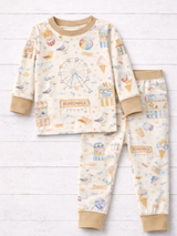 Boardwalk Baby TENCEL Lyocell two-piece pajamas with cream boardwalk print and sand trim, laid on white wood