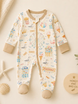 Boardwalk Baby zip-front sleeper with Ferris wheel and seagull print, styled with seashells and a wooden H&B plaque